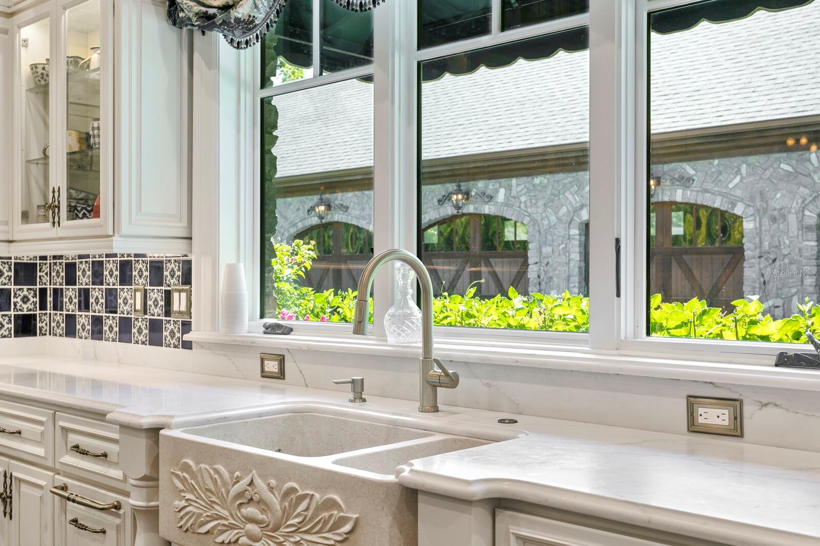 This enchanting culinary space boasts an exquisite marble countertop that adds a touch of sophistication, while ornate cabinetry whispers tales of timeless charm.