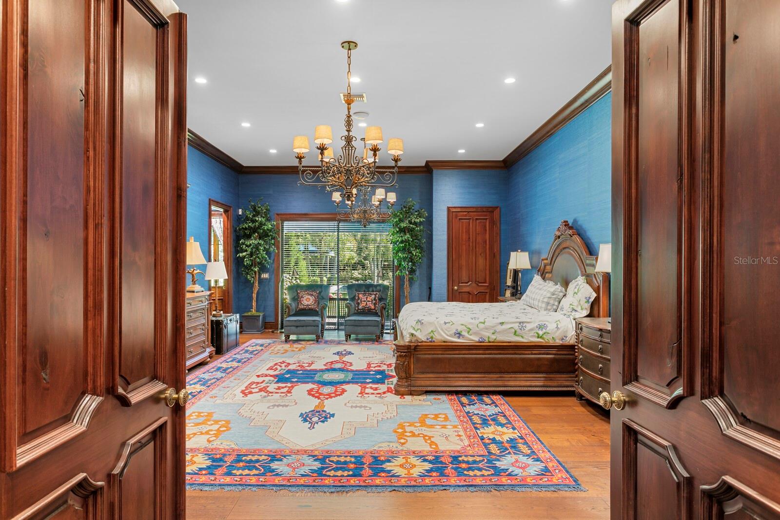 Step into the grandeur of this stunning primary bedroom, a space where elegance meets comfort in perfect harmony.