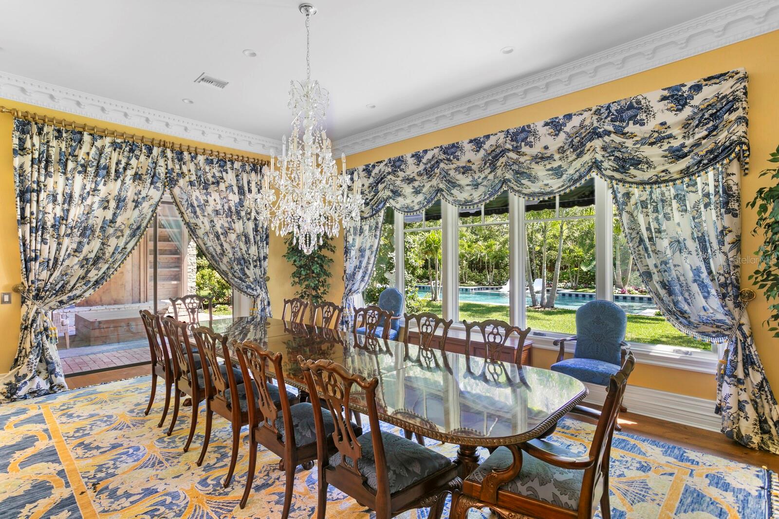 Step into a realm of opulence where this exquisite dining room awaits to charm your senses with its timeless elegance and splendor.