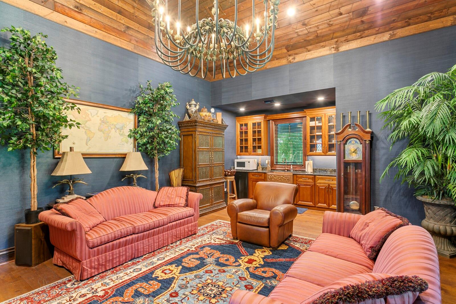 Step into a living space where elegance meets comfort, enveloped by the warm embrace of rich wooden ceilings and tastefully textured walls.