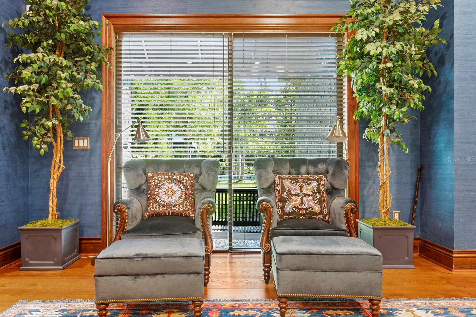 \ Bathed in natural light streaming through the expansive windows, the room exudes a sense of sophisticated tranquility.