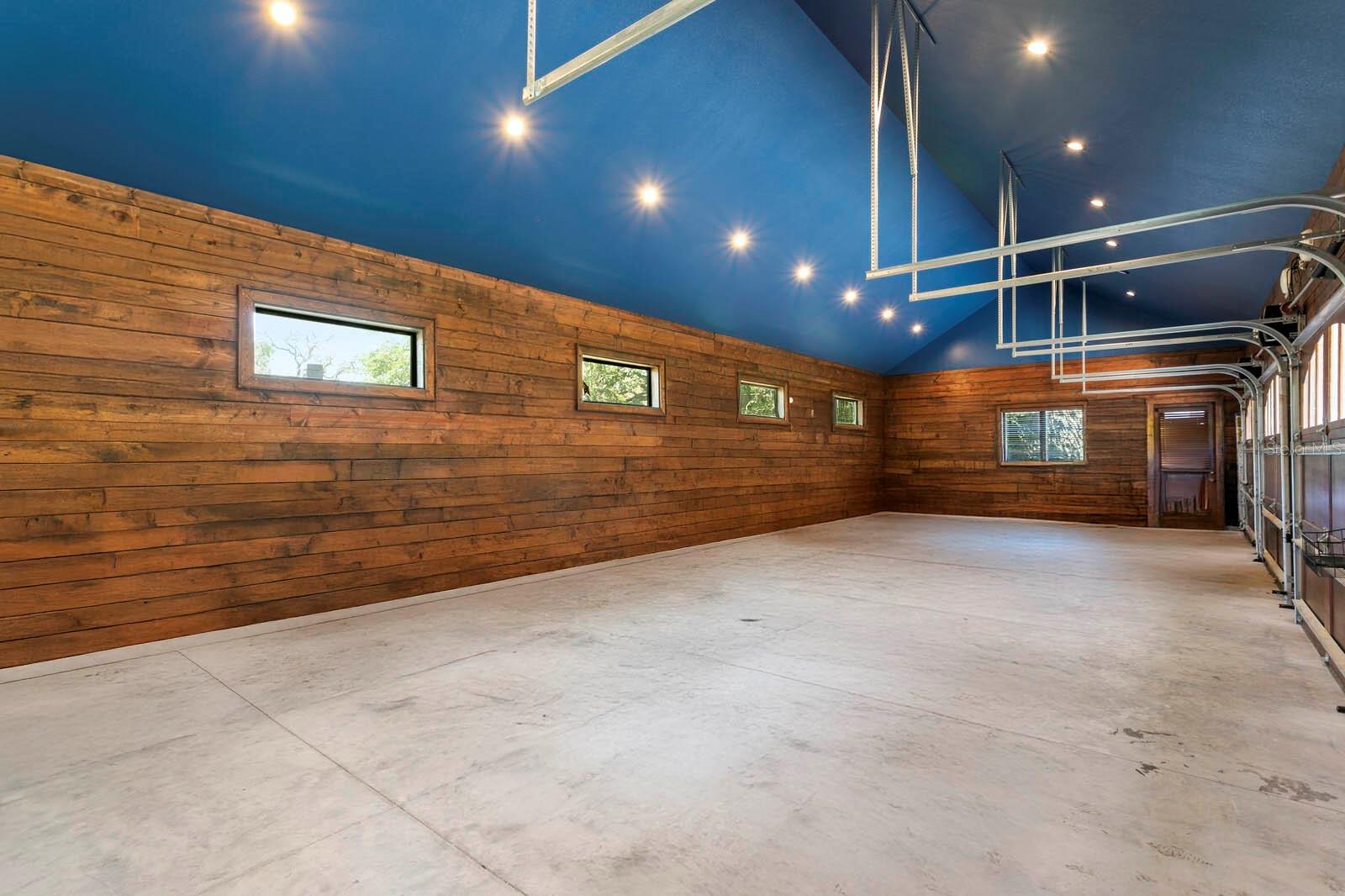 This expansive garage, illuminated by sleek recessed lighting, offers endless possibilities—envision it as a state-of-the-art workshop, a luxe studio, or an artist’s haven.