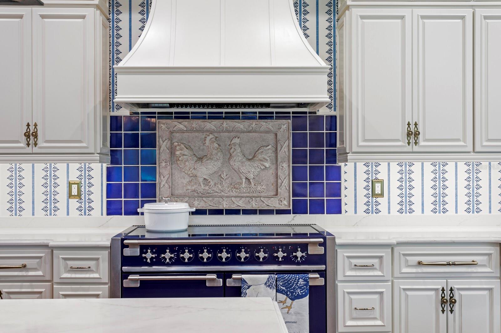 The pristine cabinetry, elegantly offset with intricate hardware, ensures style and functionality, while the luxurious range invites the creation of gourmet delights.