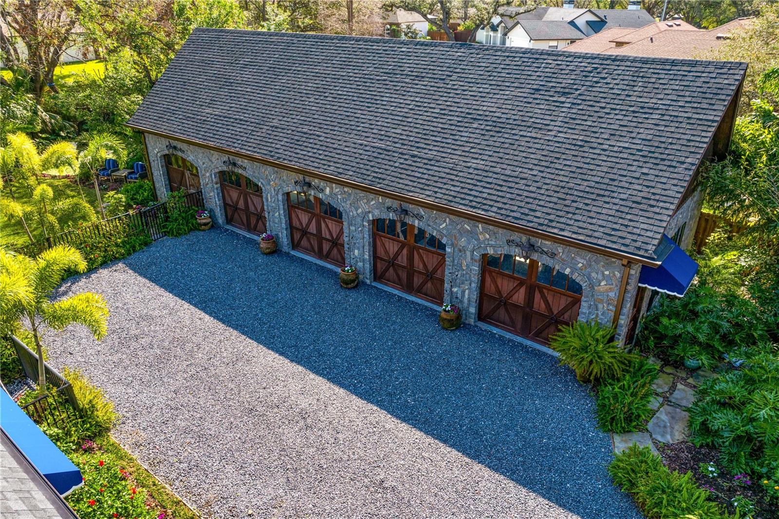 Offering ample space for all your prized possessions, the quadruple wooden garage doors exude rustic sophistication