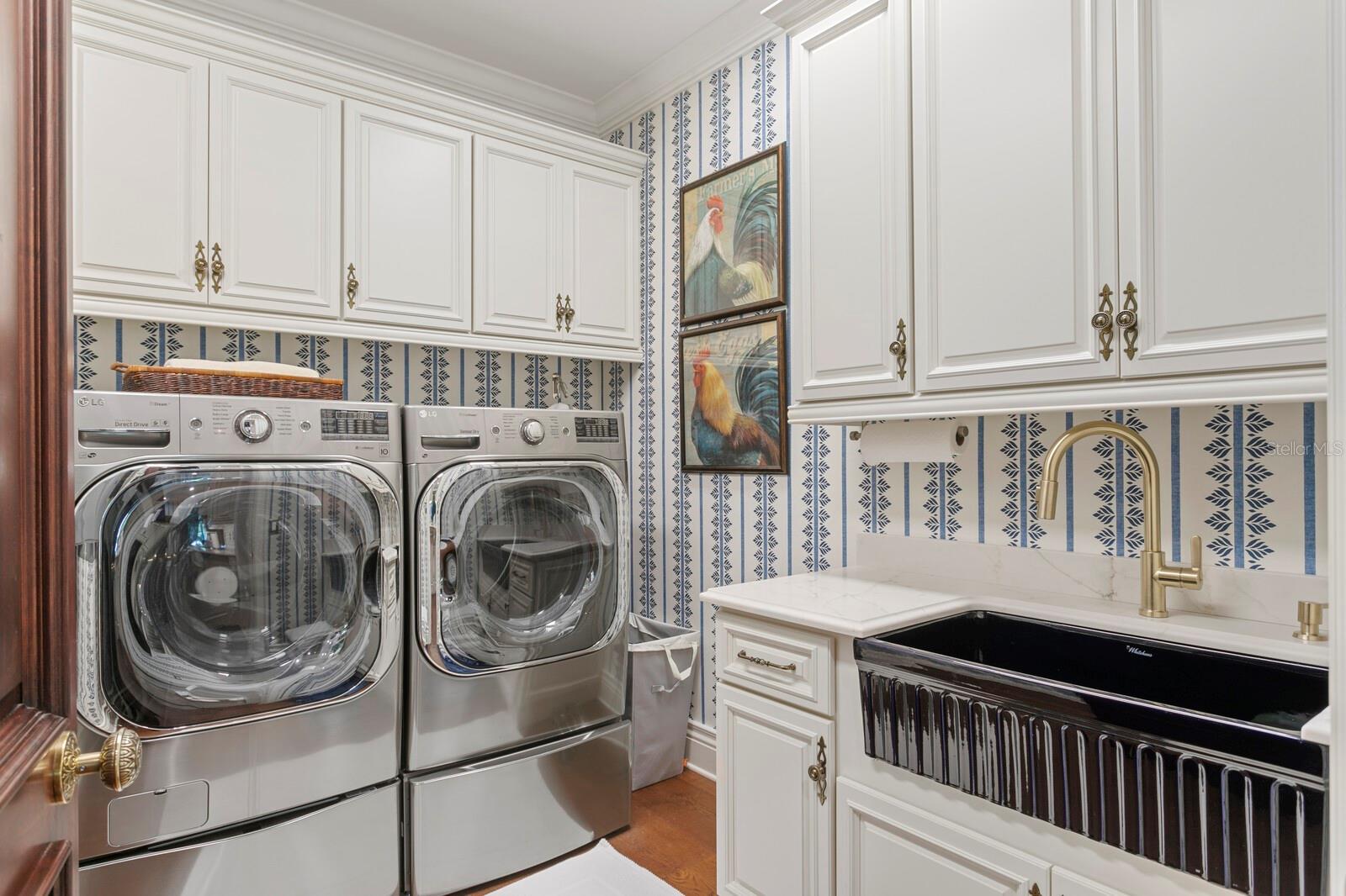 Step into a laundry room that makes washing feel like a day at a spa. The elegant cabinetry provides ample storage, ensuring everything has its place