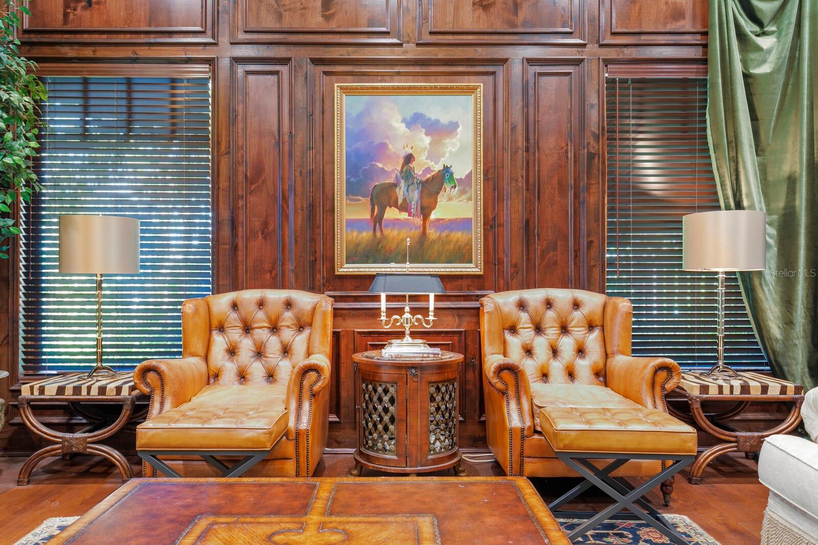 Watch as sunlight filters through the artisanal wooden blinds, illuminating the rich, warm tones of paneled walls.