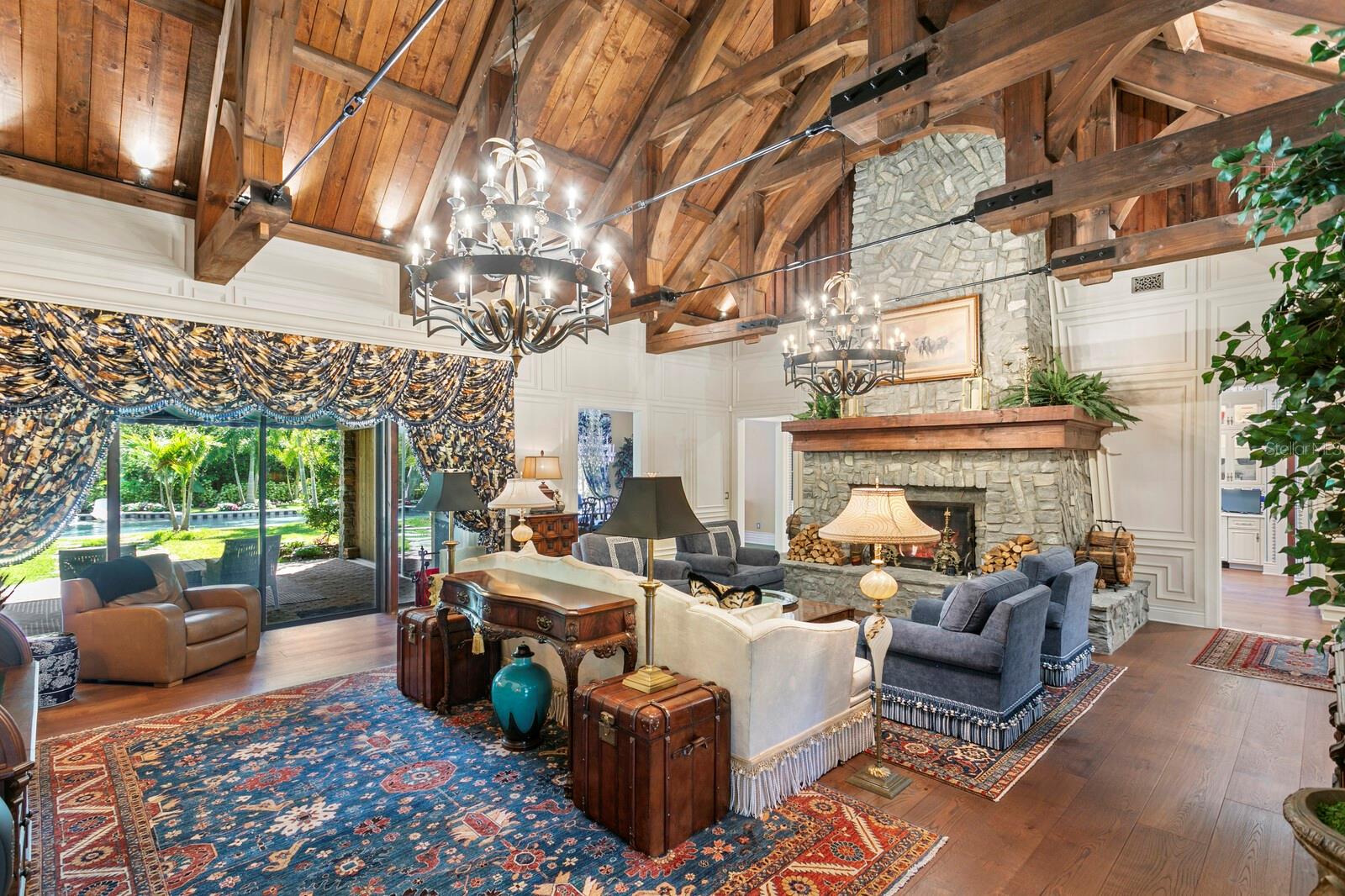 This breathtaking room boasts soaring vaulted ceilings adorned with rich, wooden beams that echo the craftsmanship of a bygone era.