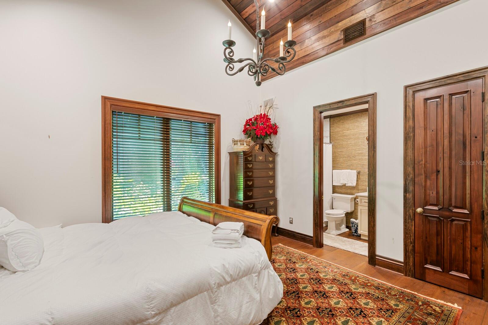 Rich wooden cabinets frame a strikingly detailed, hand-carved sink, creating an inviting focal point that combines elegance with practicality