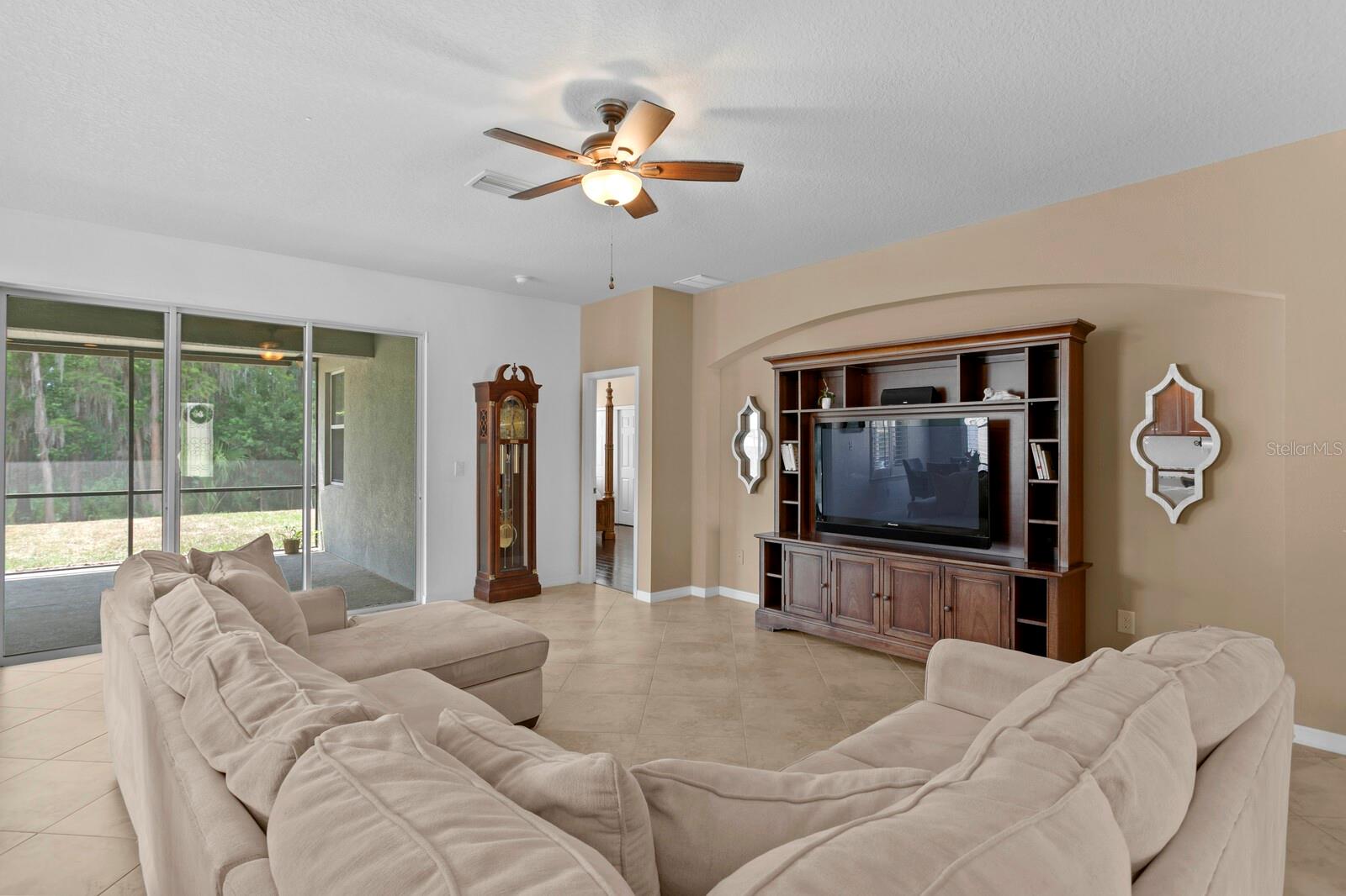 Beautiful wooded conservation views from the family room triple sliding glass doors