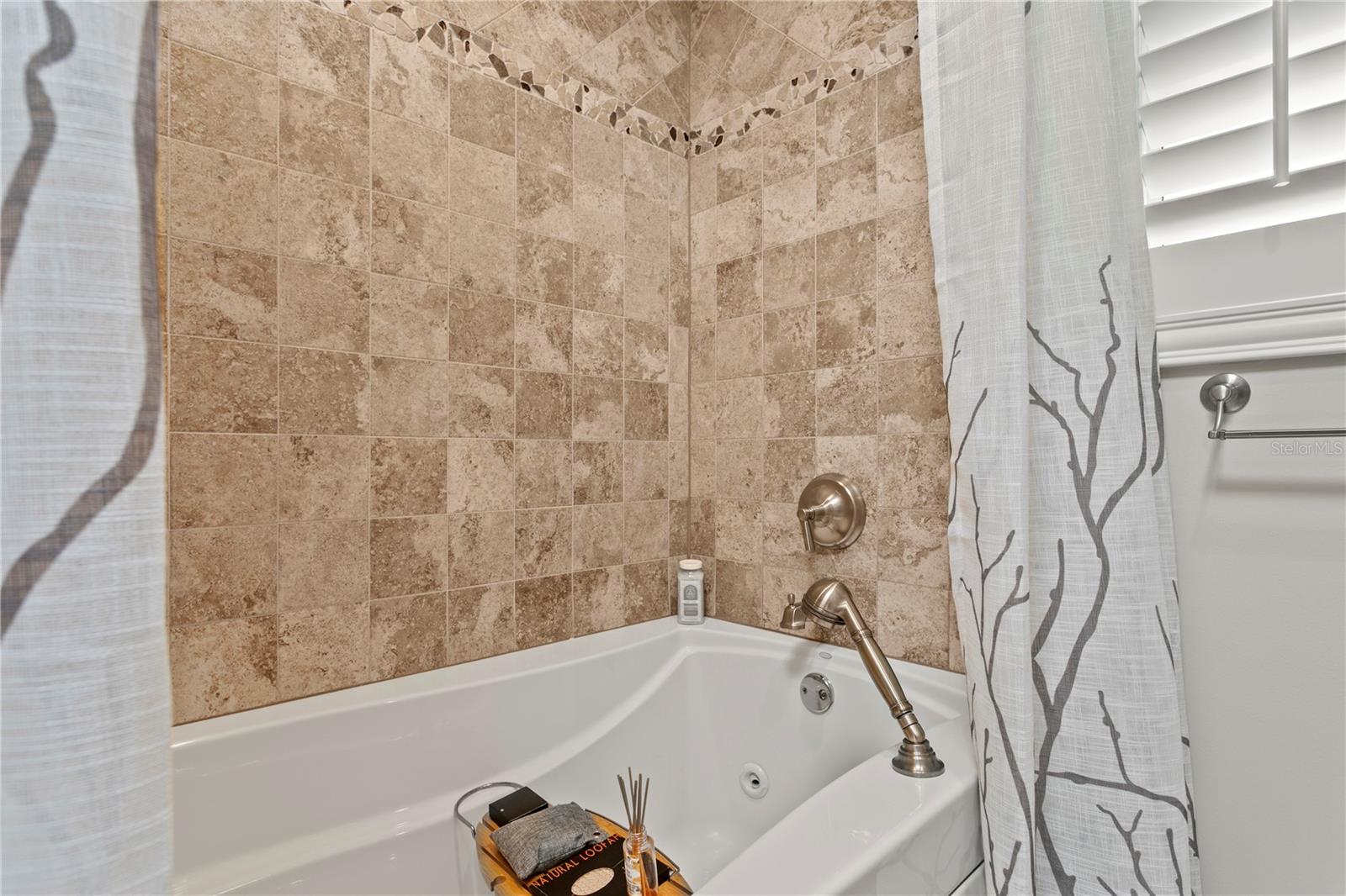 Separate tub and shower in the Jack and Jill bathroom space.
