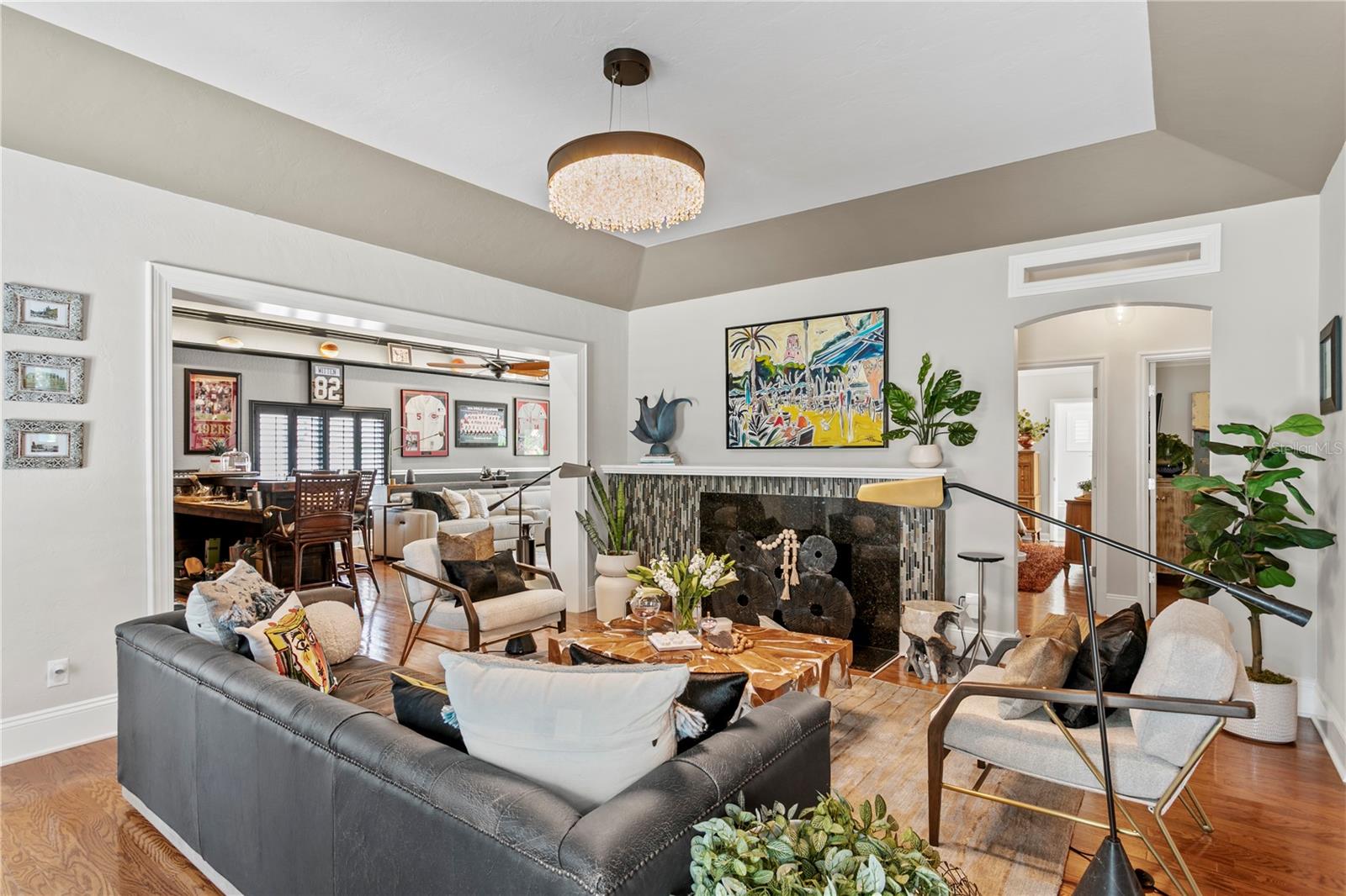 Living room opens to the guest bedrooms, great room and home office.