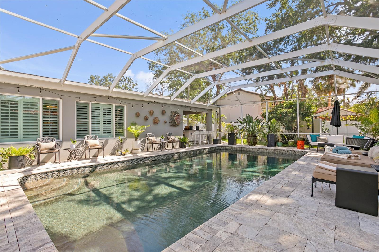 Entertaining is a breeze with the screened-in pool space.