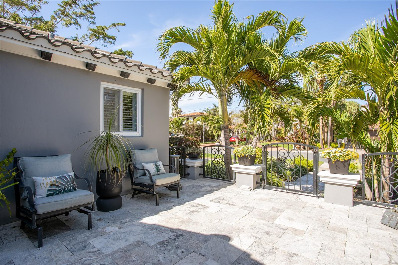 Tropical seating area on porch near front entrance.
