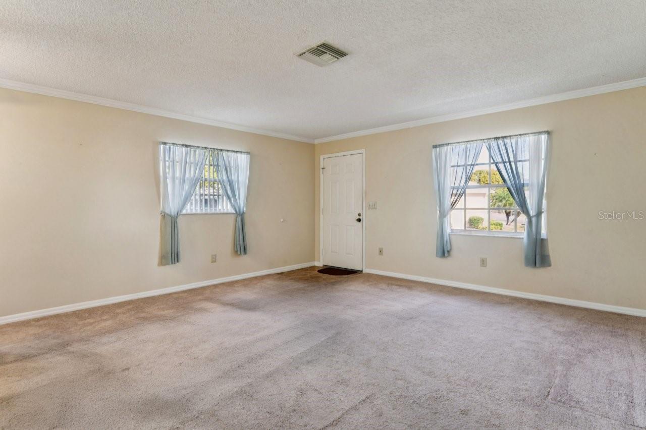 Living room has two beautiful windows.