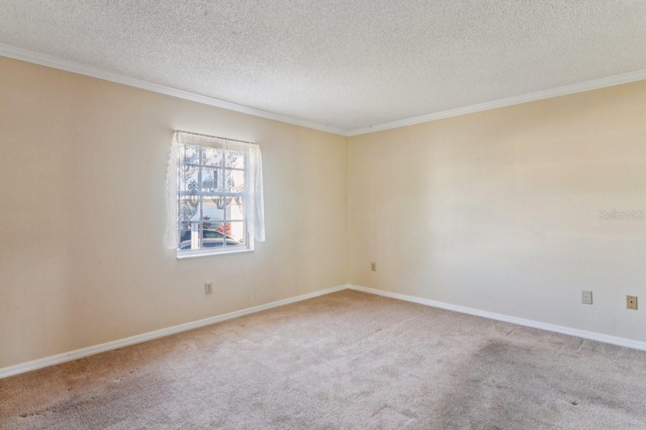 The primary bedroom features a nice window, crown molding, and a cable outlet.