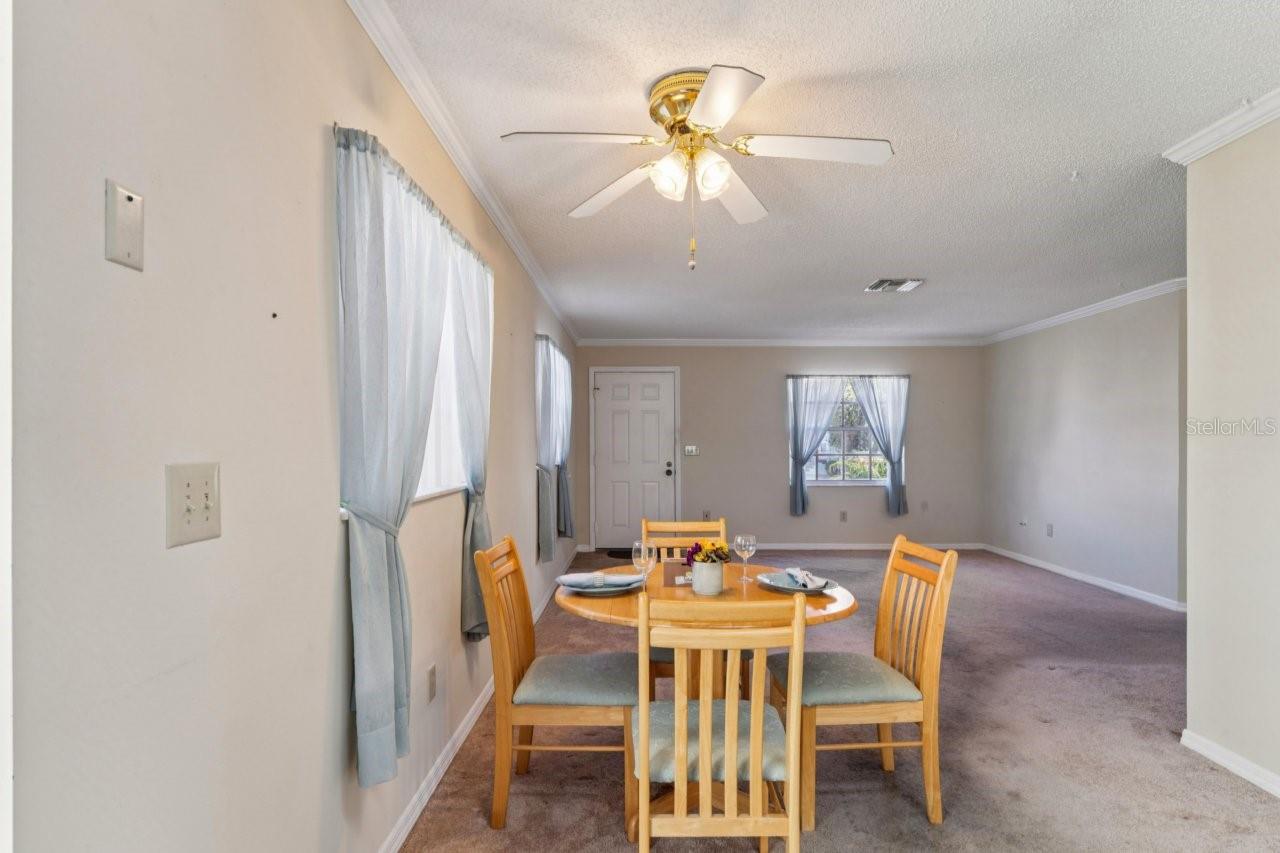 The dinette area features a window and a ceiling fan with a light, plus plenty of space for a hutch.