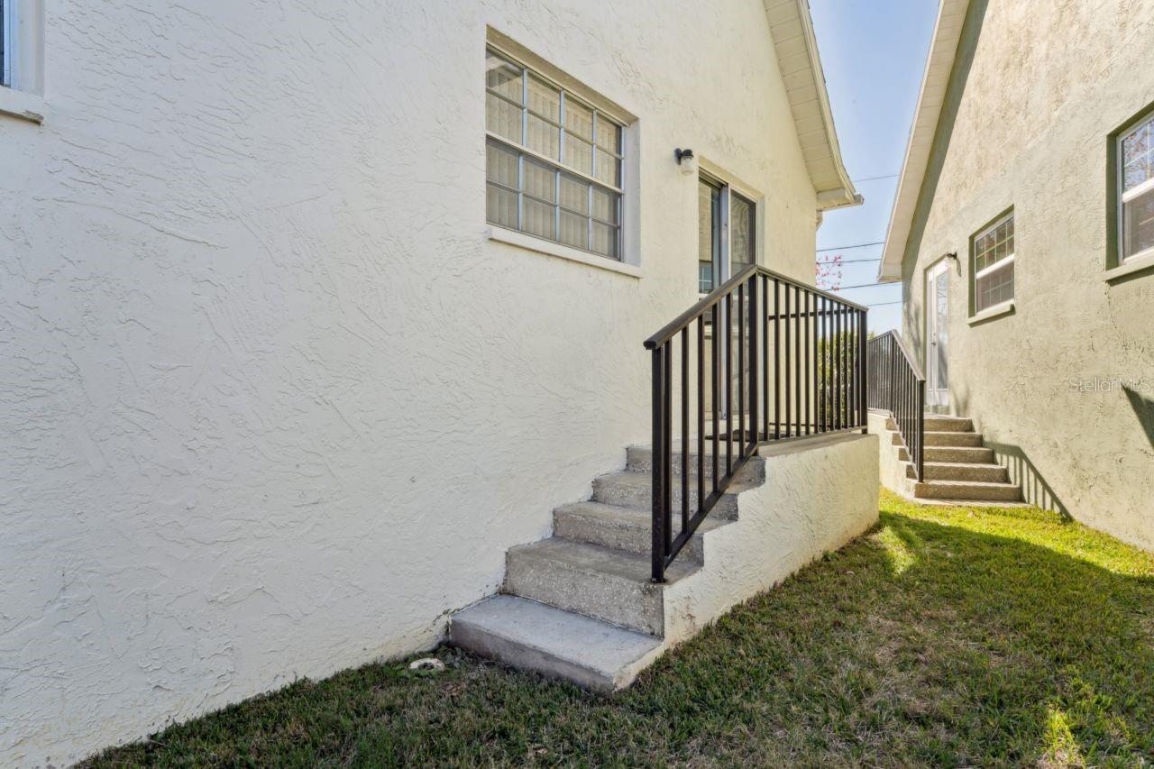 The side stairs leading to the kitchen have a sturdy railing.