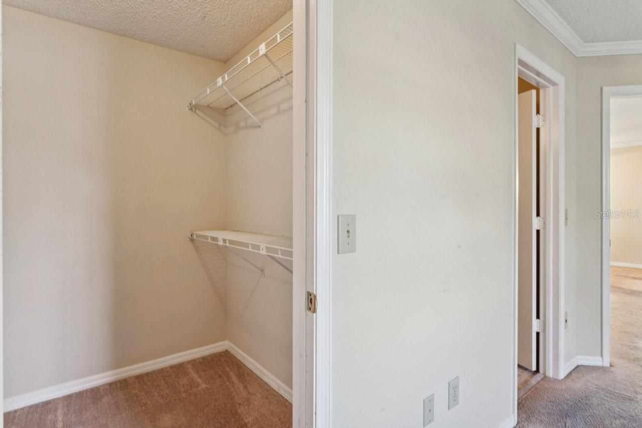 The primary bedroom features a walk-in closet with built-in shelving.