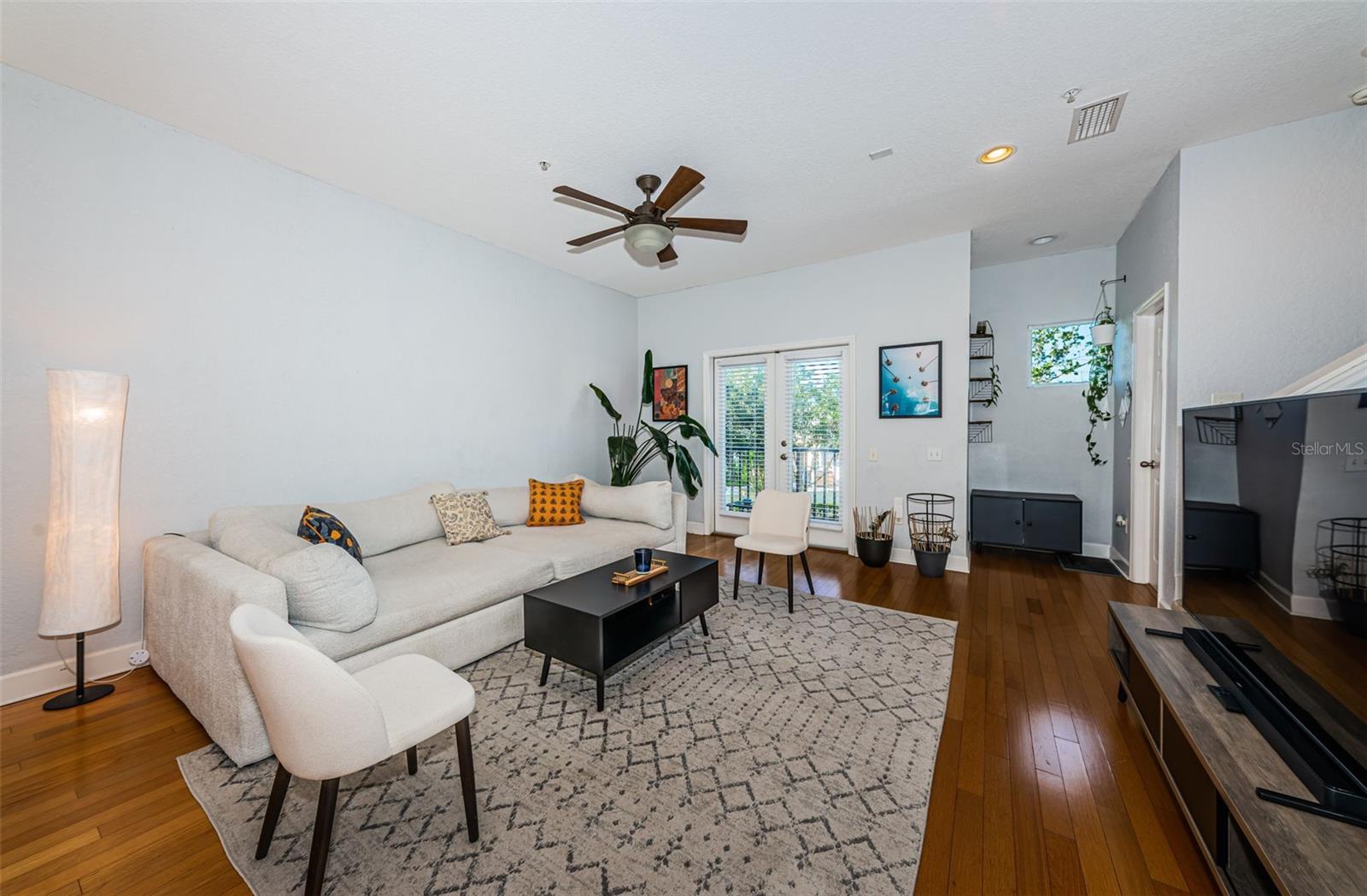 Living room has balcony that looks out towards front of the townhome.