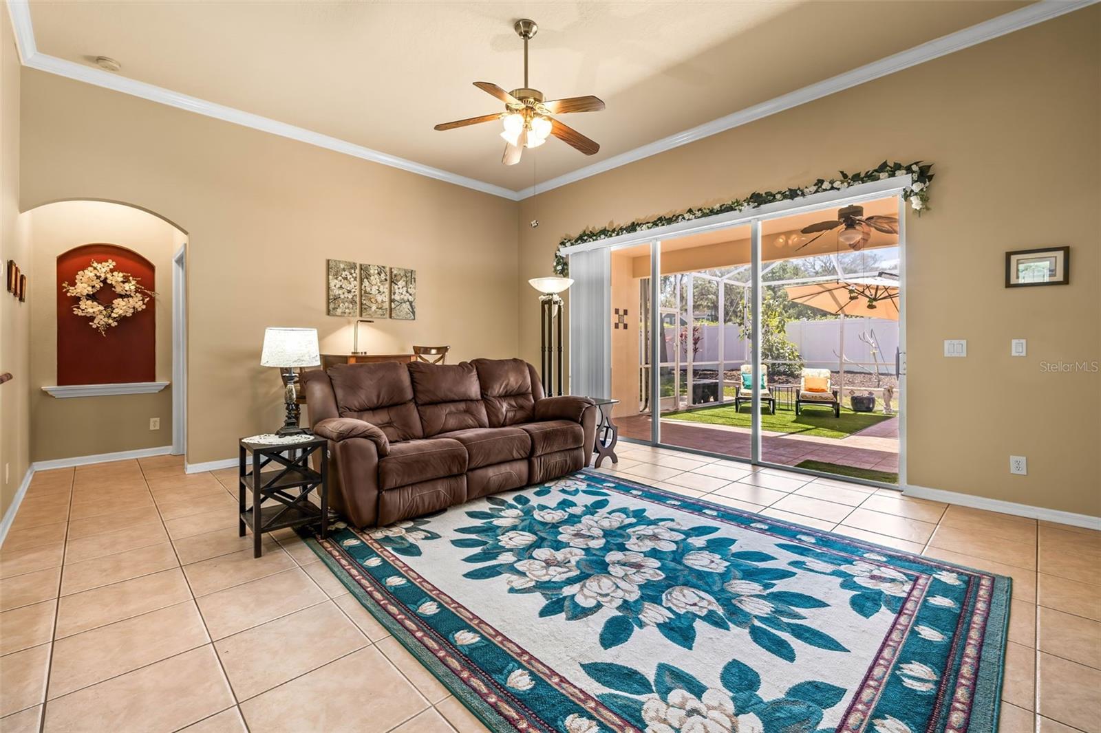 Family room with triple sliders overlooking screened lanai