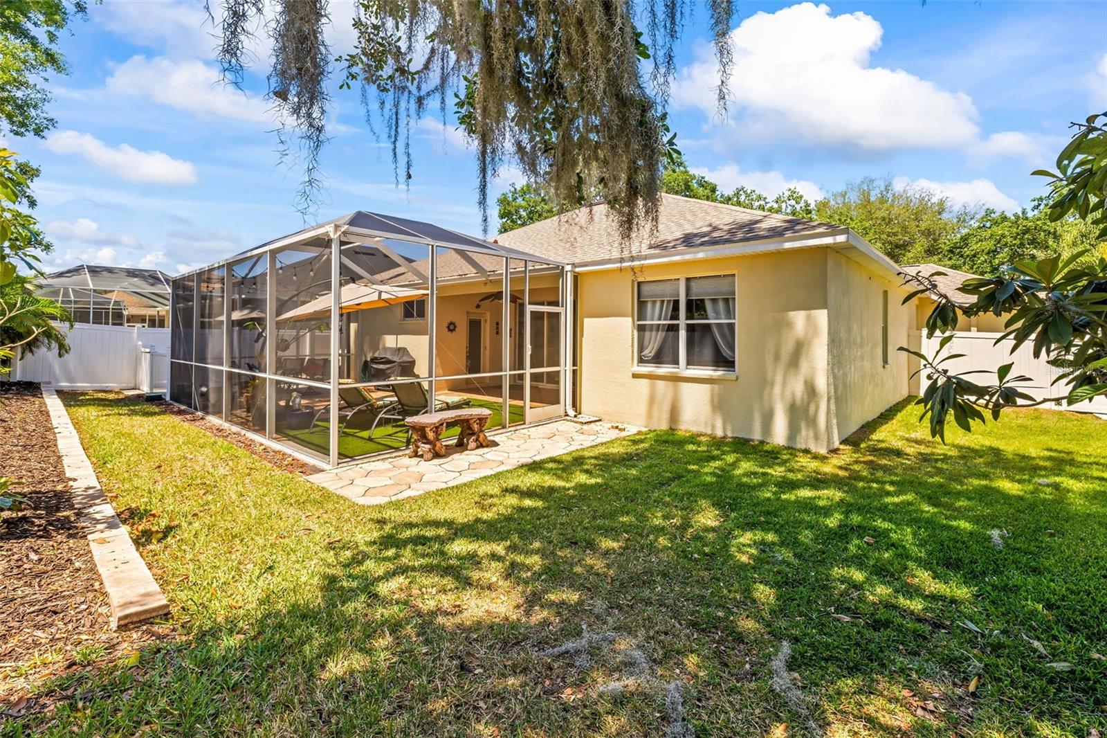 Spacious back yard with tropical landscaping