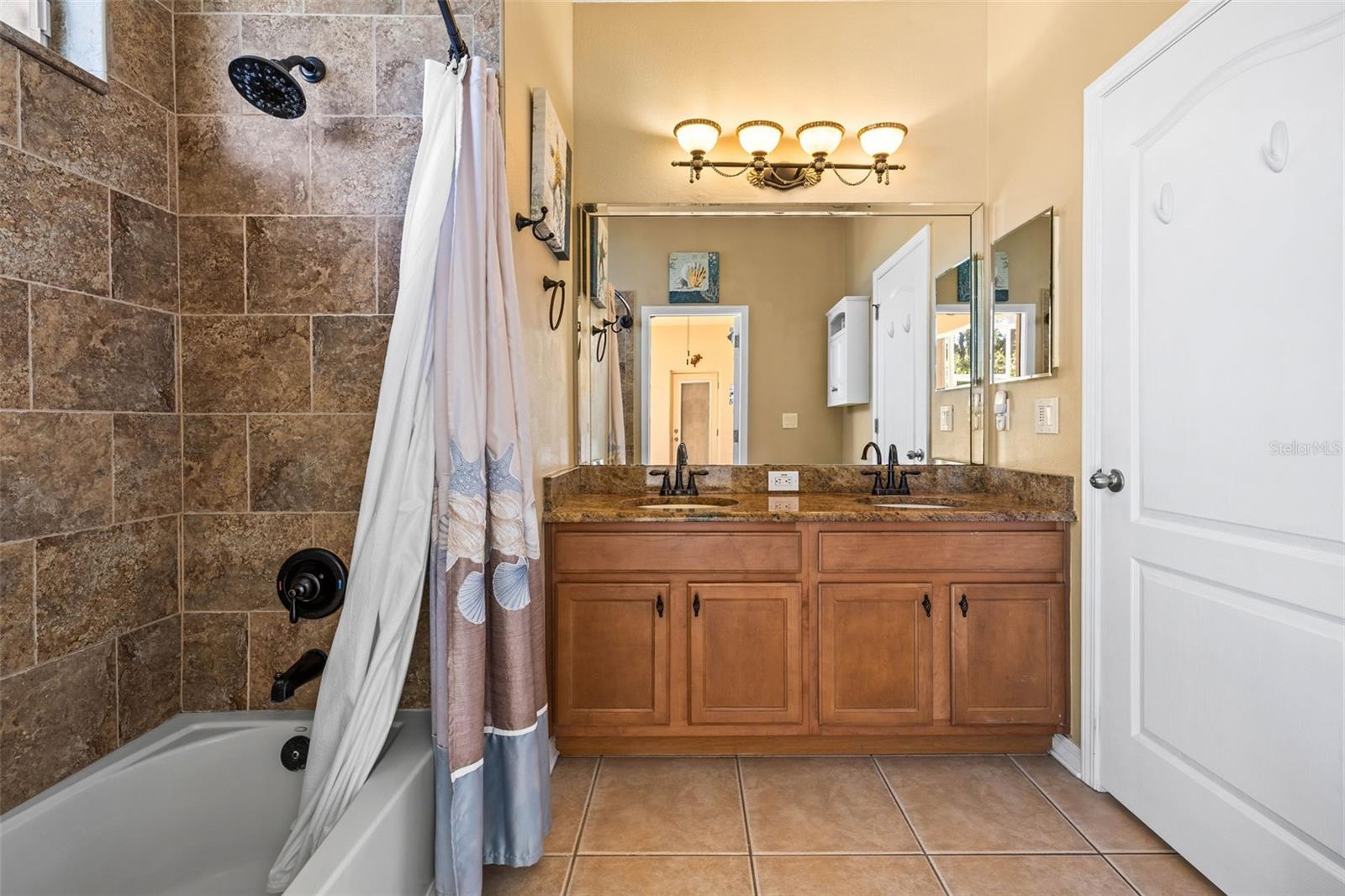 Hall Bath with dual sinks and access to lanai