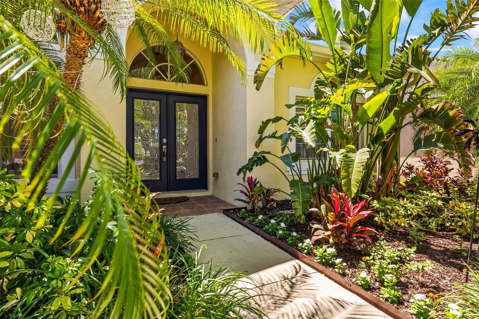 Beautiful entrance with lush landscaping