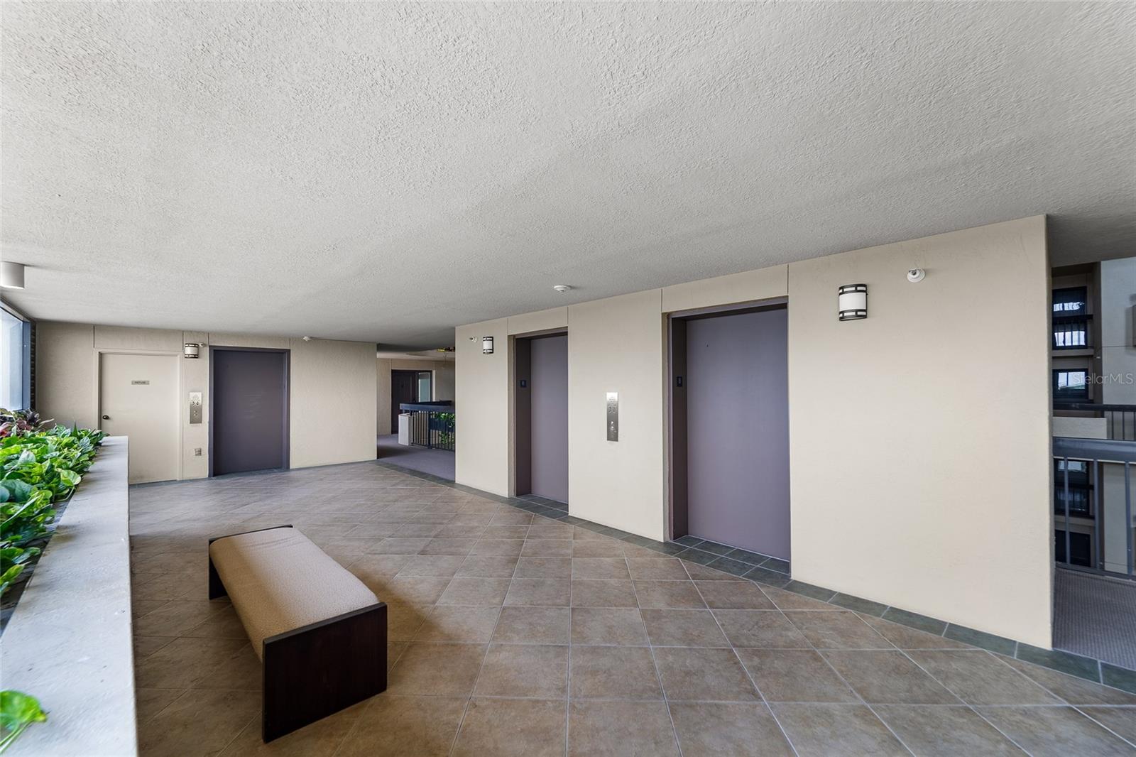 Unit very close to main elevators, utility elevator, and trash shoot.