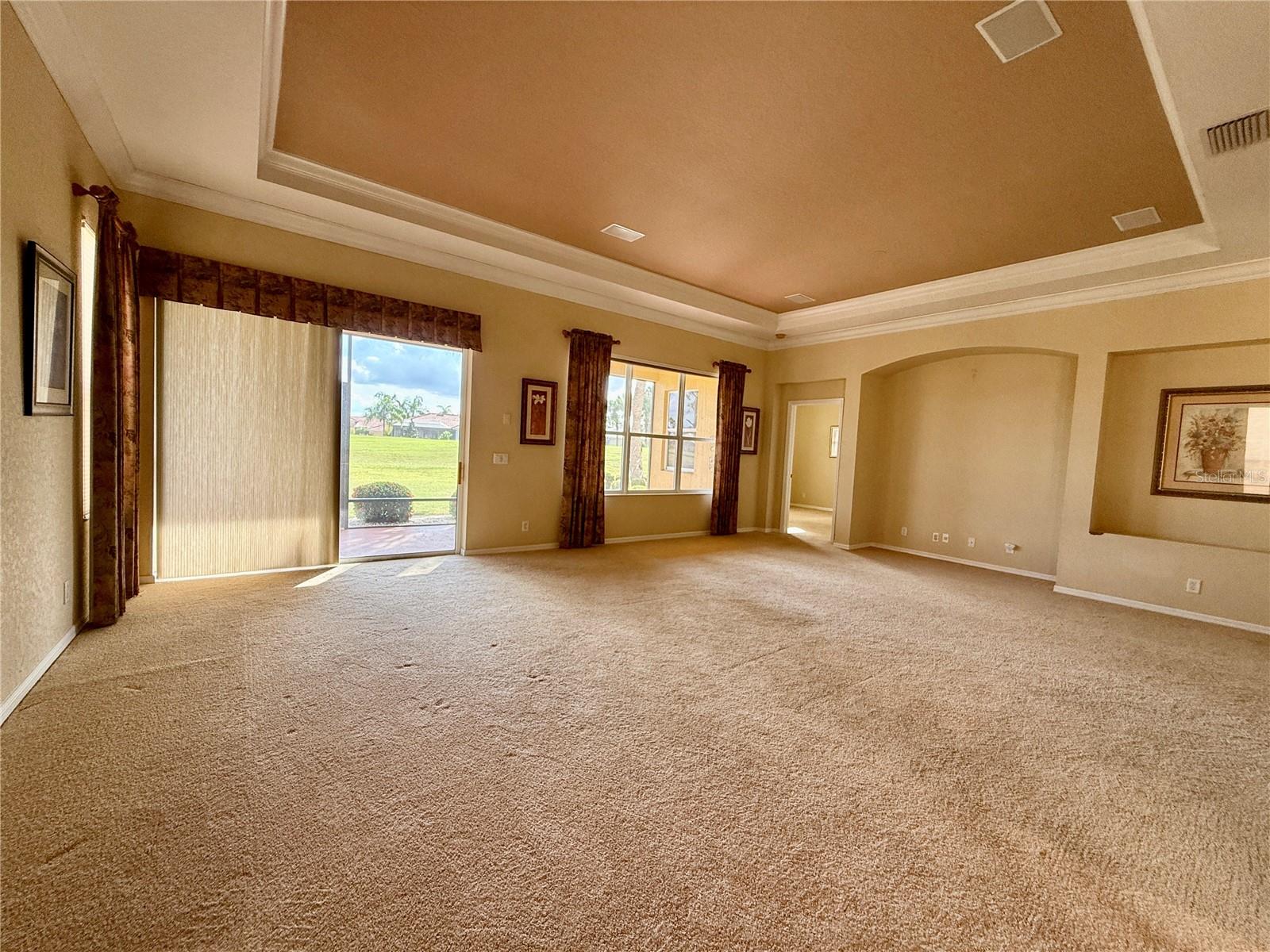 Large living room with view of golf course