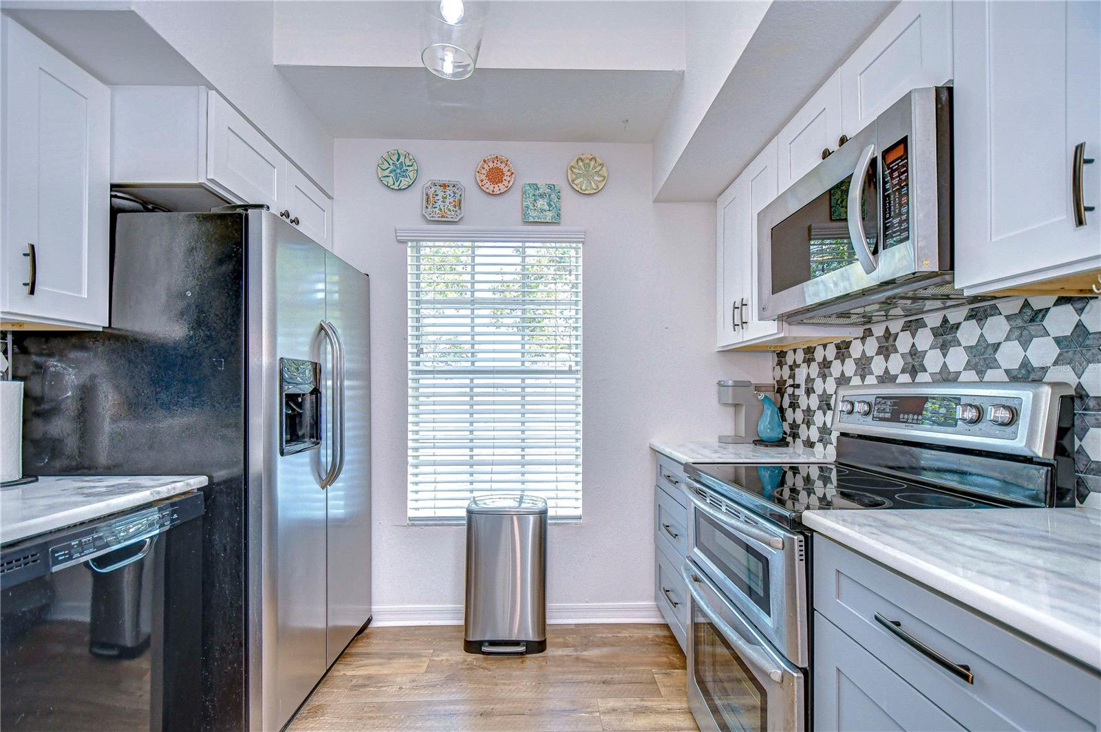 Kitchen has view of the Lake from window. Appliance's include double oven, dishwasher, refrigerator, and microwave.