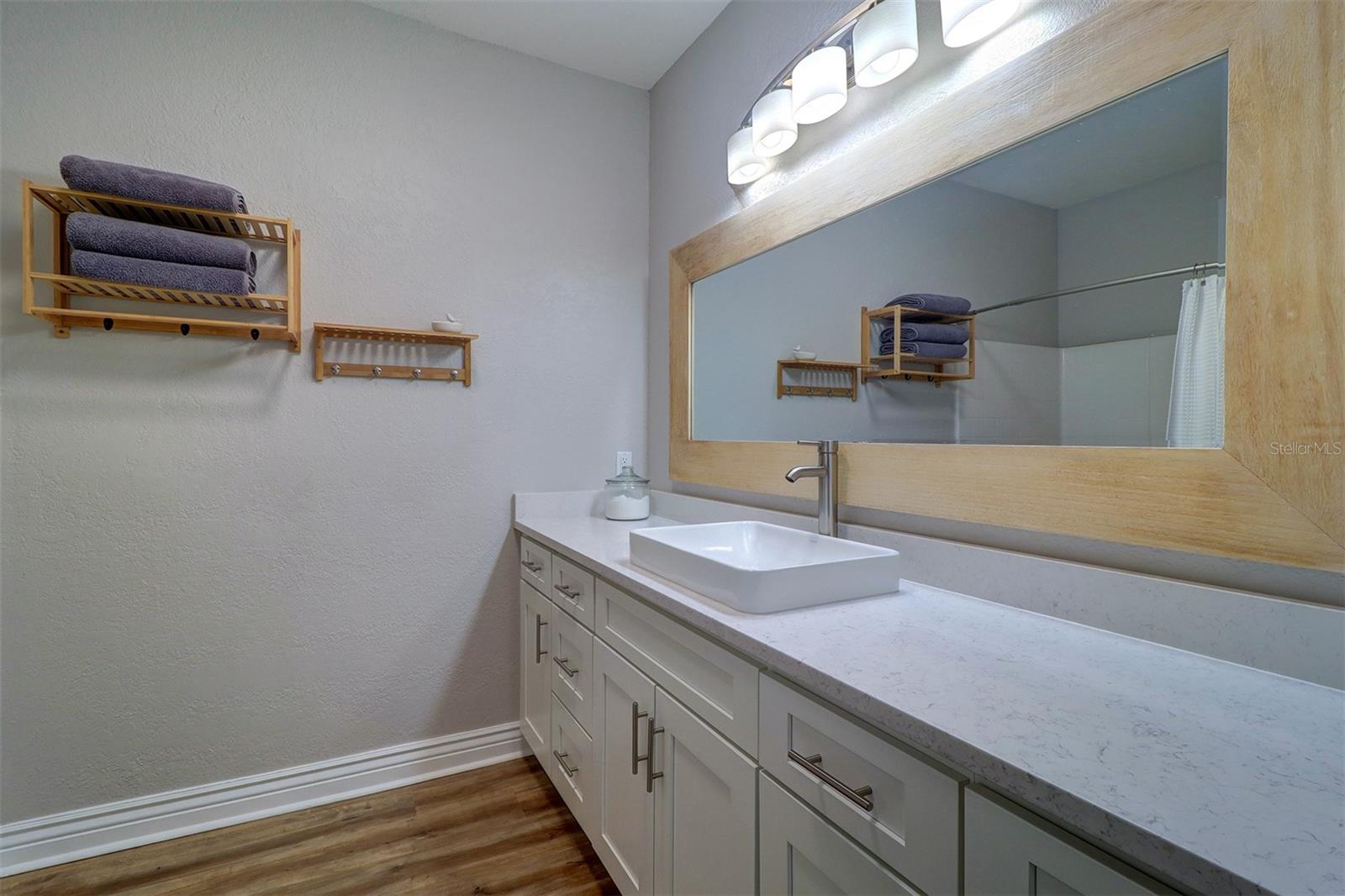 Updated primary bathroom with new vanity, vessel sink, mirror and light fixture