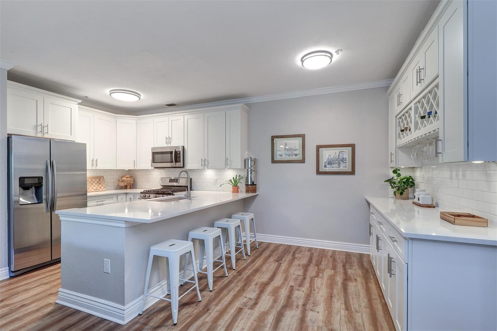 Kitchen eat in area between kitchen island and wine/coffee/dry bar