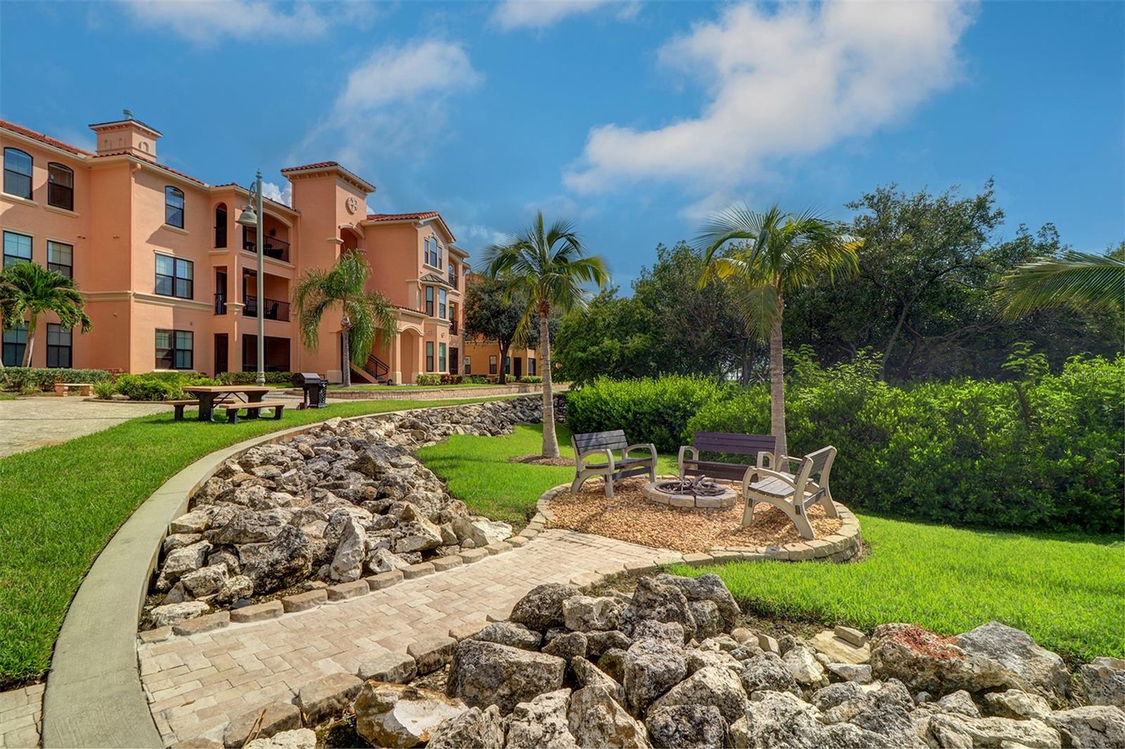 fire pit with benches on the promenade and behind the pool on the interior water inlet