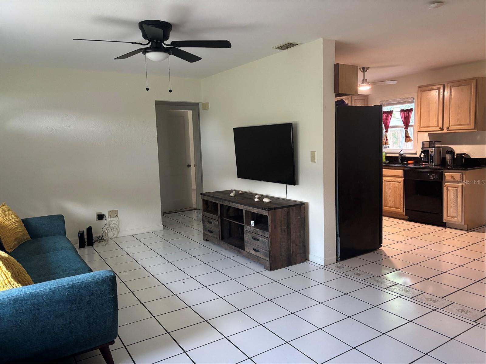 looking from dining room in to living room and kitchen