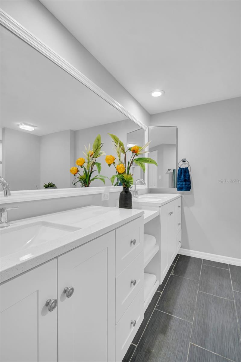 Primary Bathroom with Dual Sinks and Cabinets
