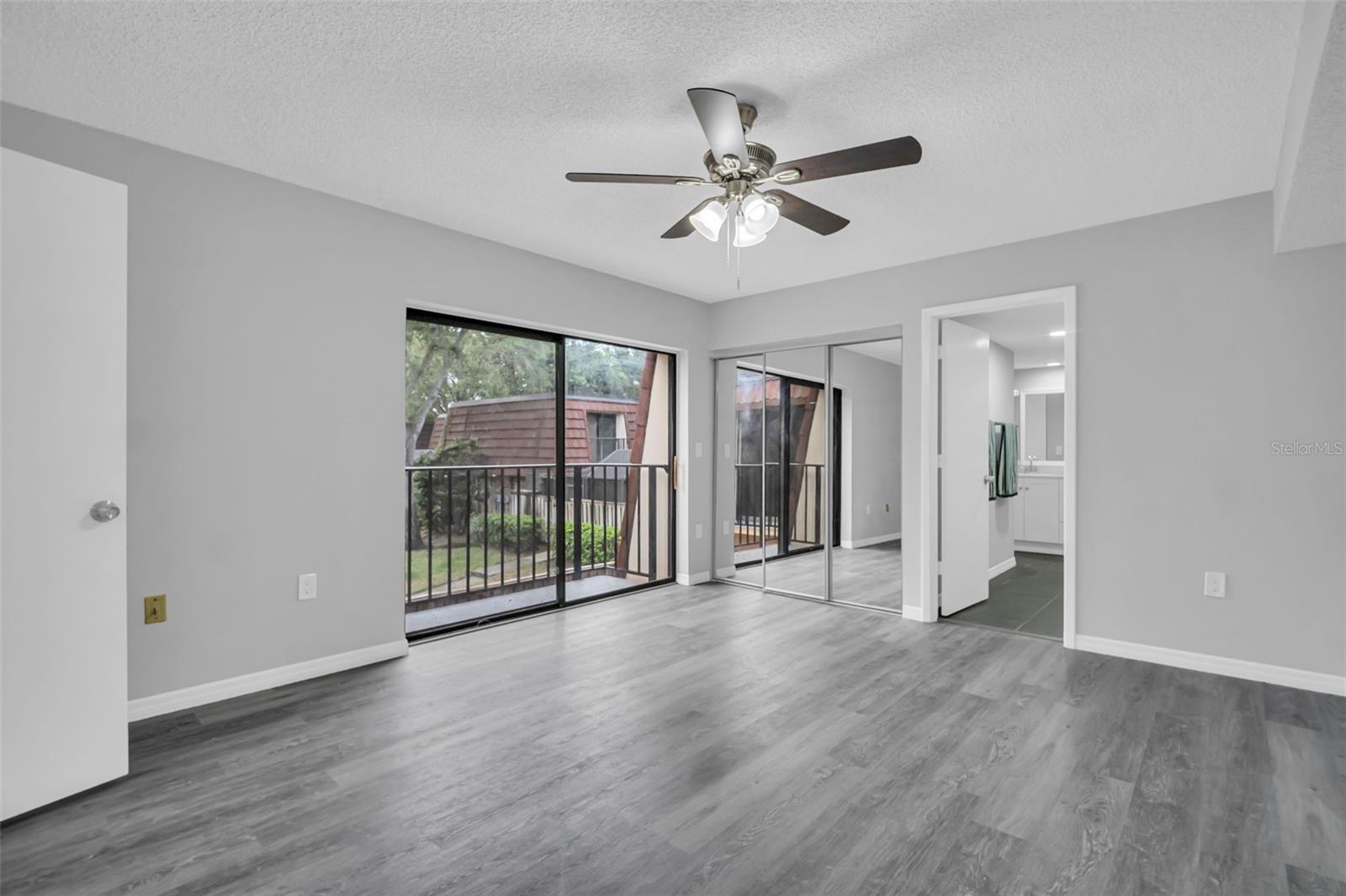 Primary Bedroom with Private Balcony and Walk-In Closet