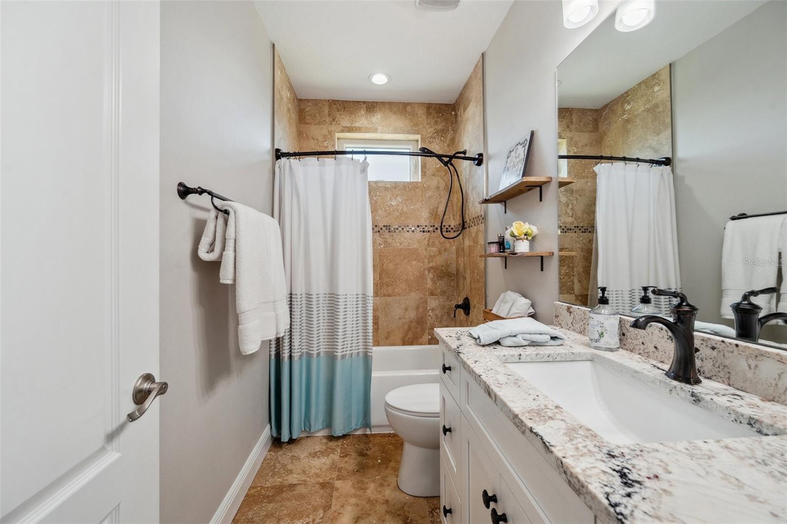 Shared bathroom on 3rd floor includes solid wood vanity with stone counter.