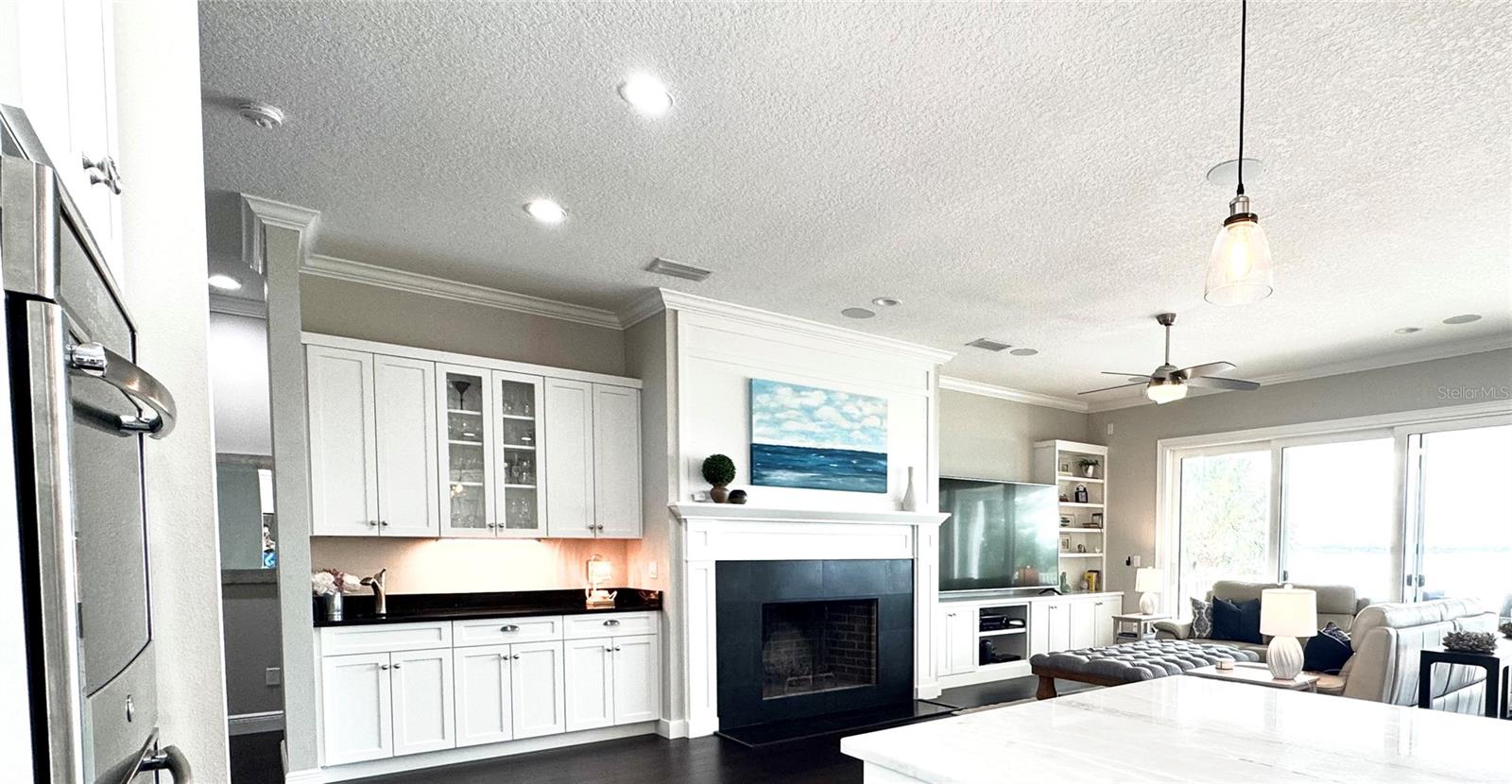 Fireplace and quality custom trim and built-ins by renowned DuraSupreme Cabinets.