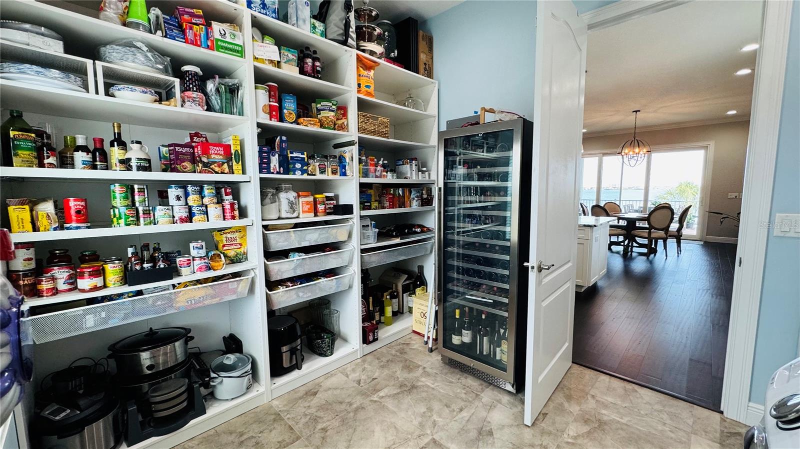 A walk-in pantry/laundry room is conveniently located behind kitchen wall. Plenty of space for a large wine fridge.