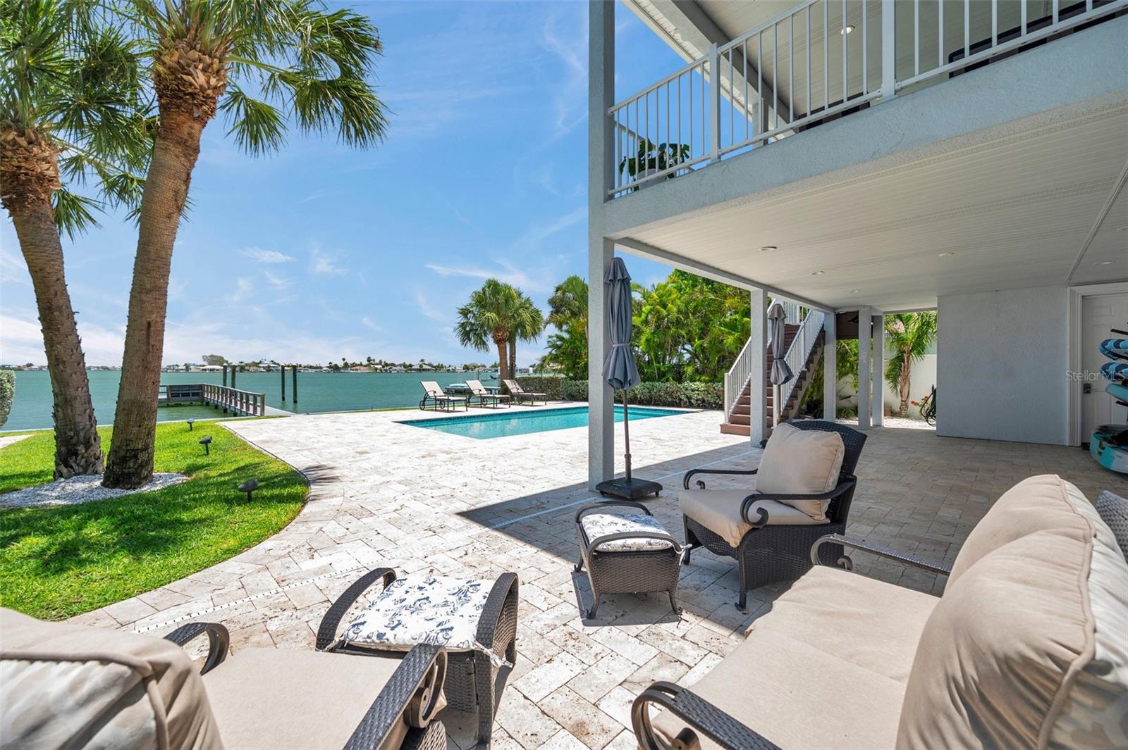 Large pool deck with ample room for entertaining. Covered lanai and oversized 2nd floor balcony offer shade.