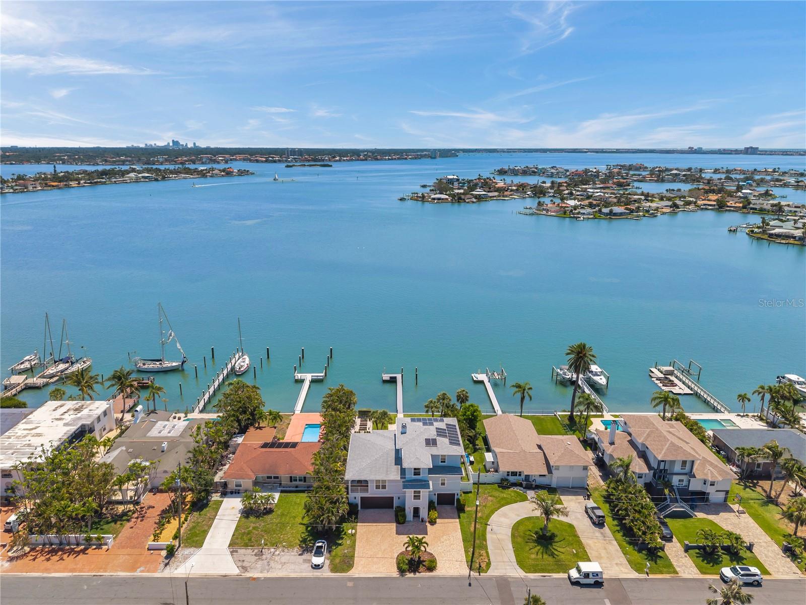 Aerial view of home showcasing the wide-open waters of Boca Ciega Bay. Easy walk to the beach, plus there are two small islands within paddleboarding/kayaking distance.