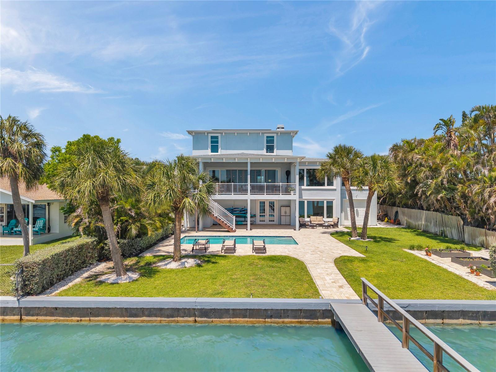 Back of home from the 72 foot Trex dock. Fenced and lush foliage on either side provide privacy.