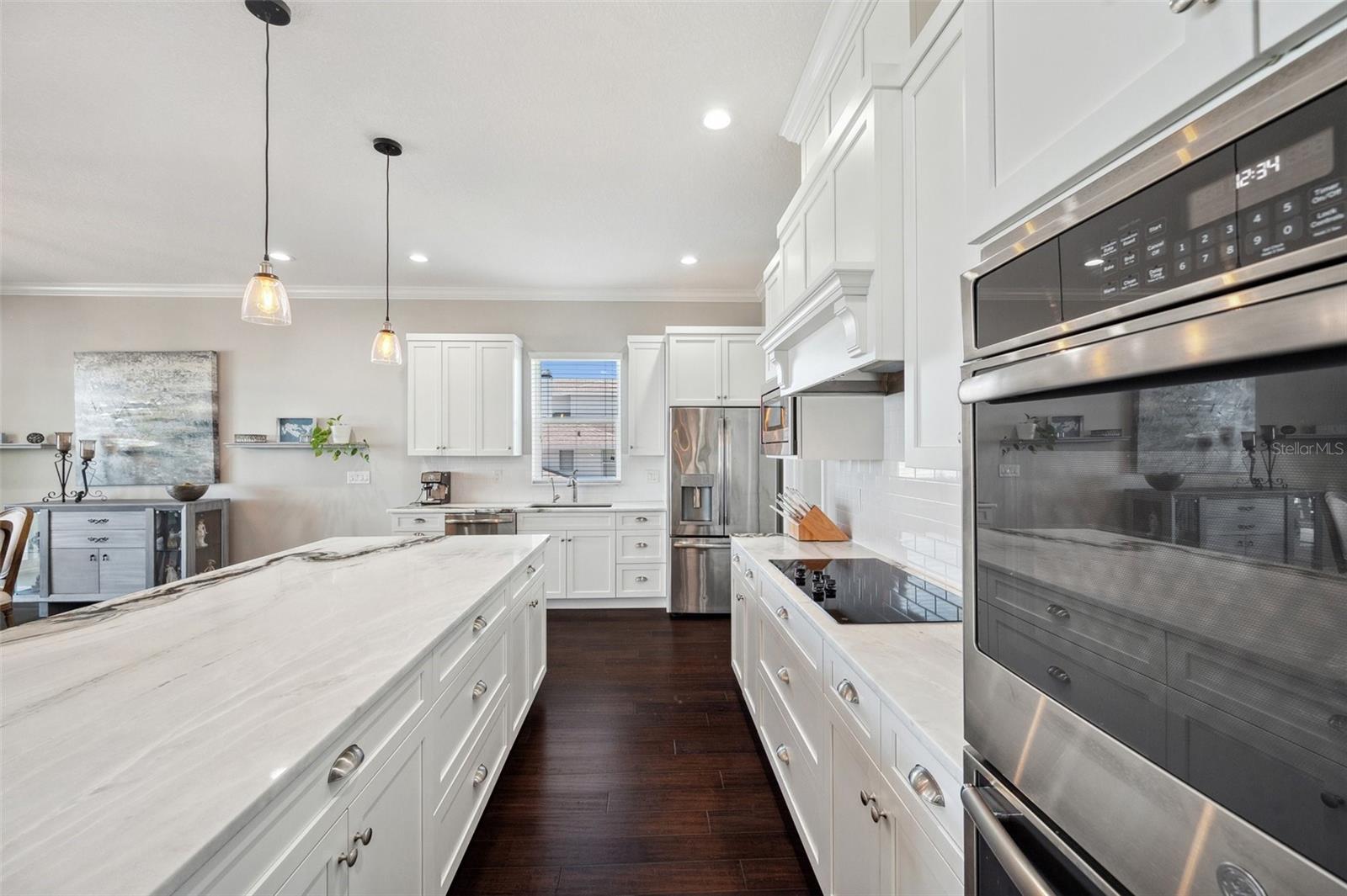 Kitchen boasts double ovens, a new GE cooktop and dishwasher, oversized center island, and reverse osmosis water filtration system.
