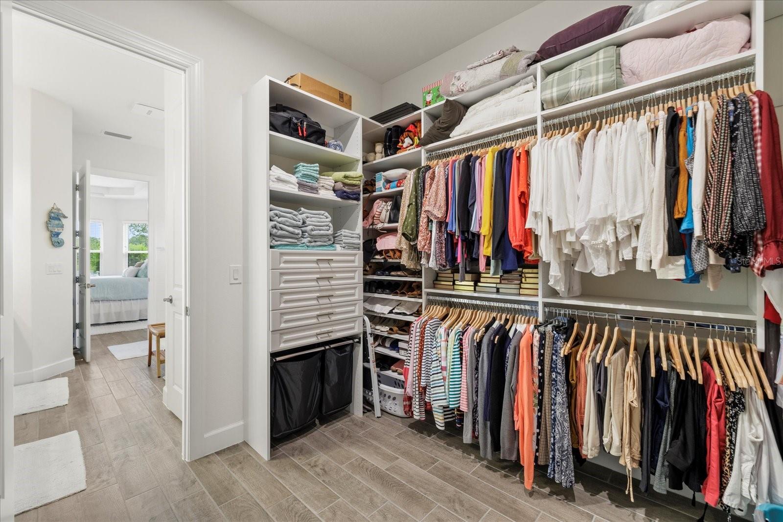 Primary suite closet with built-in jewelry organization drawers