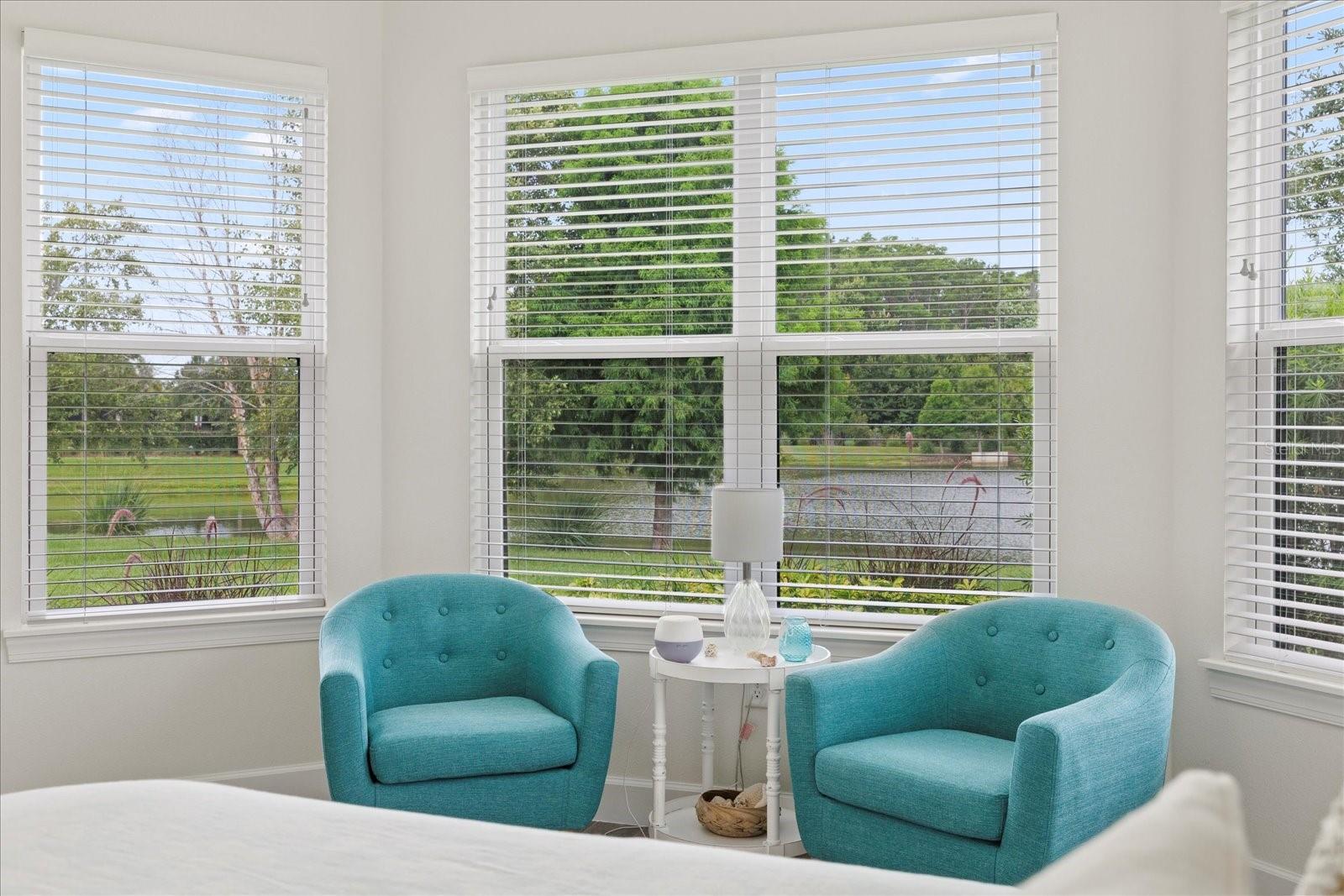 Primary bedroom seating area with water views