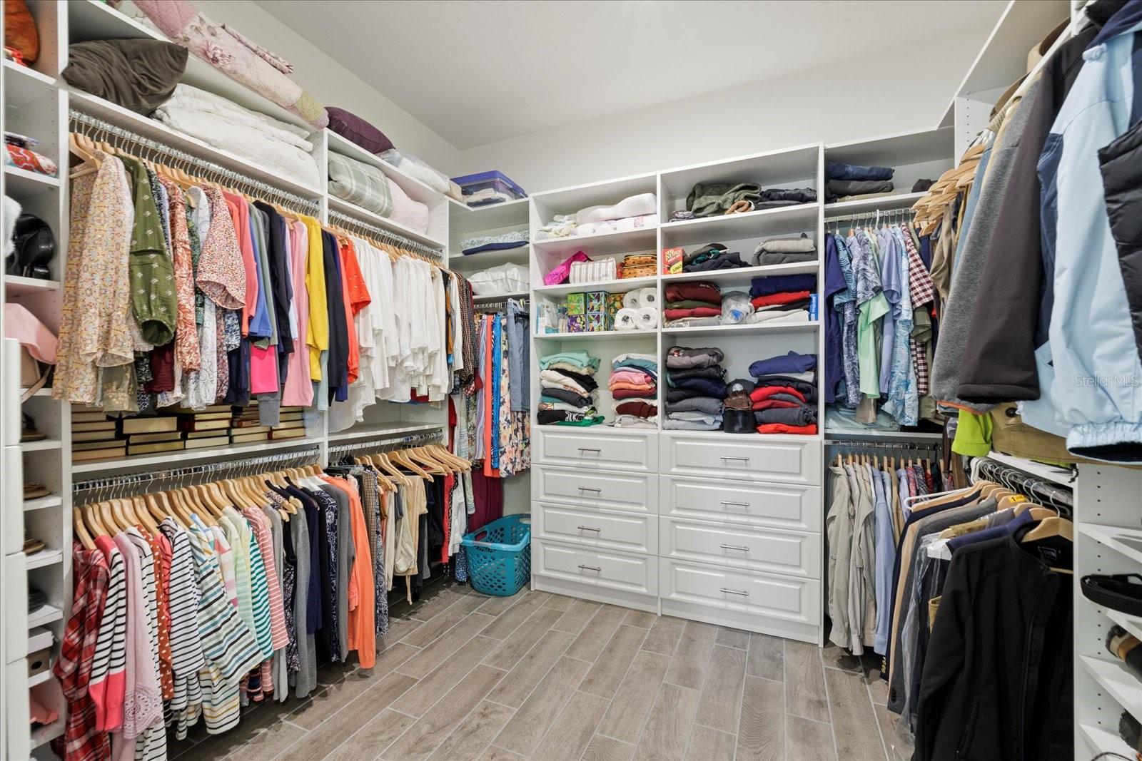 Luxury walk-in closet in primary suite with ample storage.