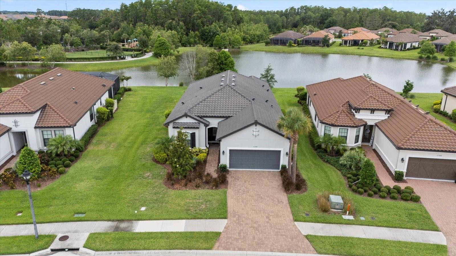 Aerial front view of home with pond behind