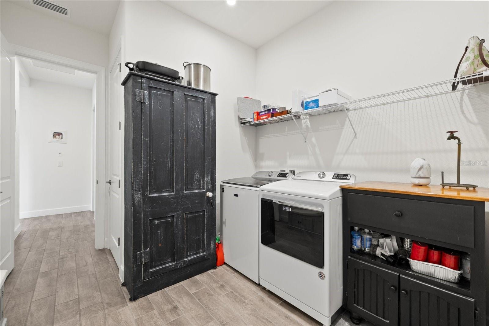 Indoor laundry room with utility sink.
