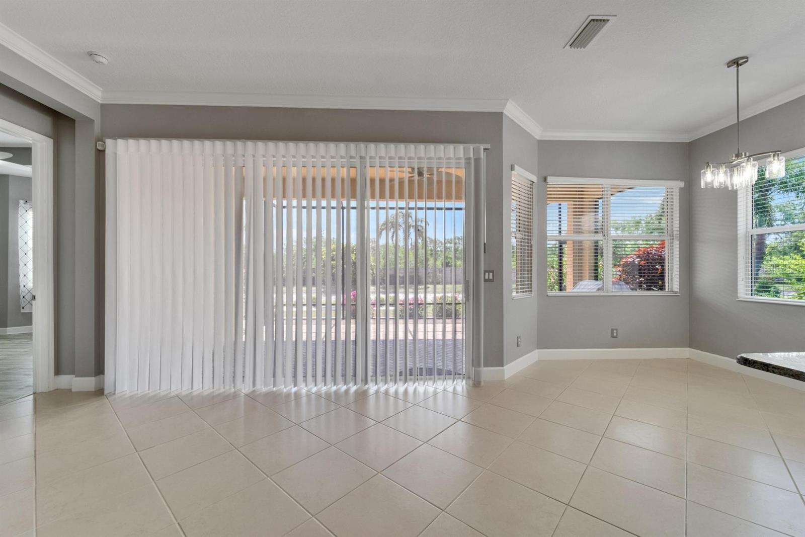 Extended lanai with custom fabric blinds that allows sun and breeze