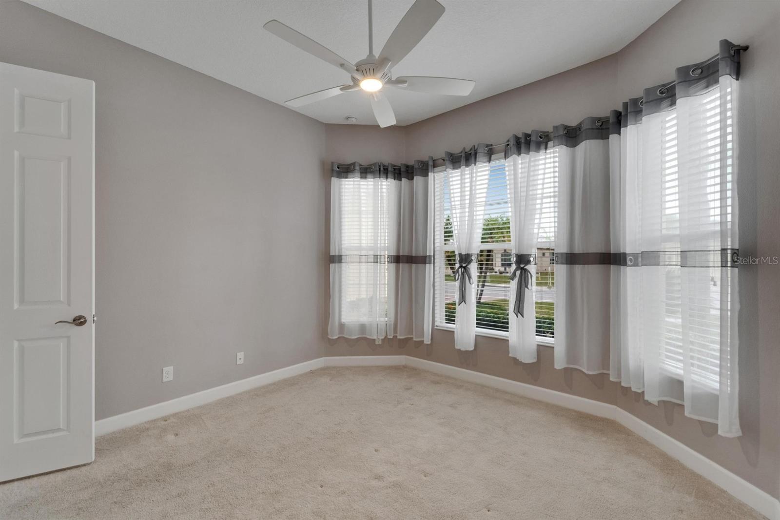 Guest Bedroom has bay window and carpet